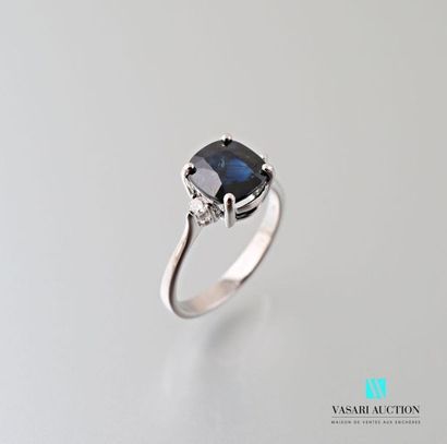 null 750 thousandths white gold ring set in its center with a cushion-cut sapphire...
