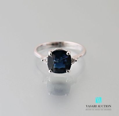 null 750 thousandths white gold ring set in its center with a cushion-cut sapphire...