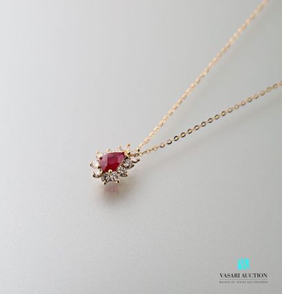 null 750 thousandths yellow gold pendant and chain with a pear cut ruby calibrating...