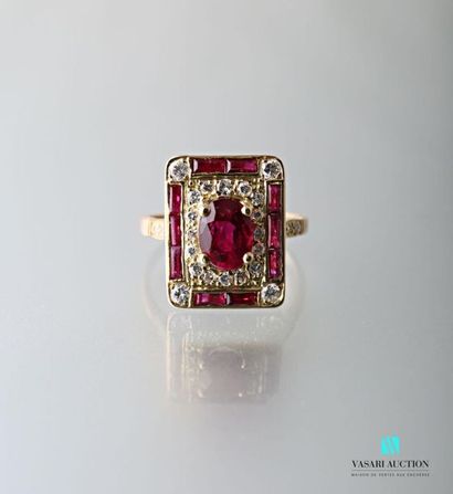 null 750-thousandths yellow gold ring, rectangular design with a central oval ruby...