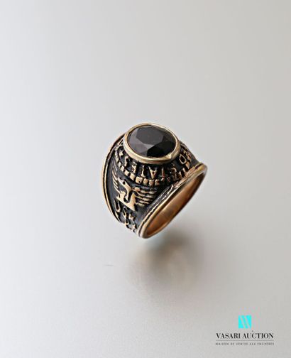 null Gold-plated metal ring marked United States Navy and centered with a black faceted...
