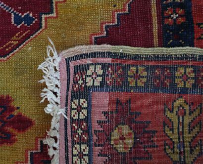 null Woollen rug decorated with a central medallion decorated with stylised floral...