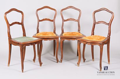 null A suite of four chairs in moulded natural wood, with an animated backrest adorned...
