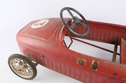 null A child's pedal car made of red painted sheet metal, bearing the number 3, it...