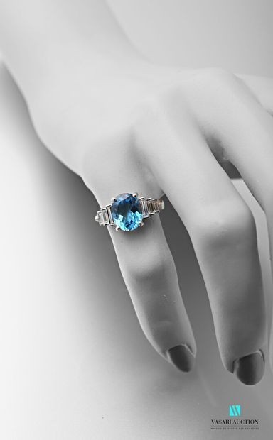 null 750 thousandths white gold ring set with an oval-shaped blue topaz of approximately...