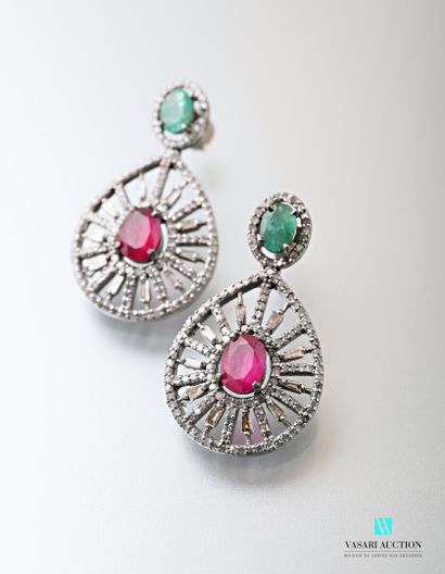 null Pair of openwork piriform silver earrings centered with an oval cut ruby in...