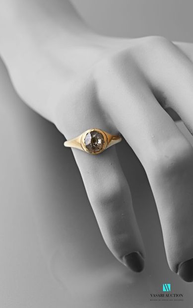 null 750 thousandths yellow gold ring set with an antique cut diamond of approximately...