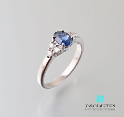 null A 750 thousandths white gold ring centered on an oval-shaped sapphire calibrating...