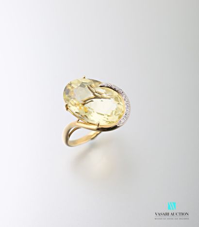 null 750 thousandths yellow gold ring adorned in its centre with a faceted oval faceted...