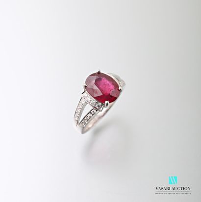 null 750 thousandths white gold ring set with an oval-shaped treated ruby calibrating...