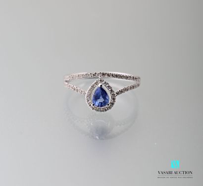 null 750 thousandths white gold openworked body ring set with a pear-cut sapphire...