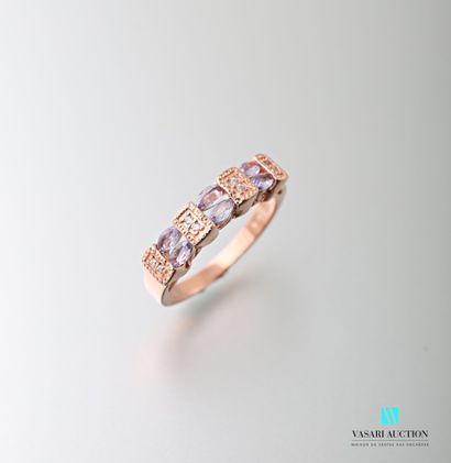 null Half ring in pink vermeil set with two rows of treated tanzanites alternating...