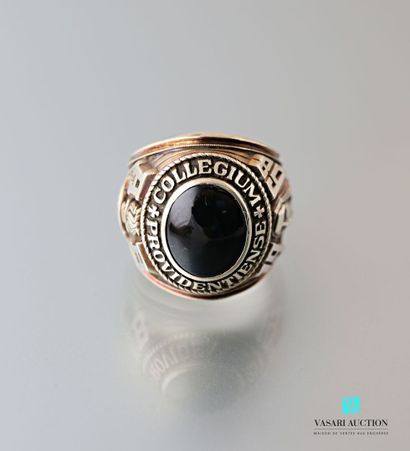 null 9 karat gold university ring set with a cabochon onyx encircled by the inscription...