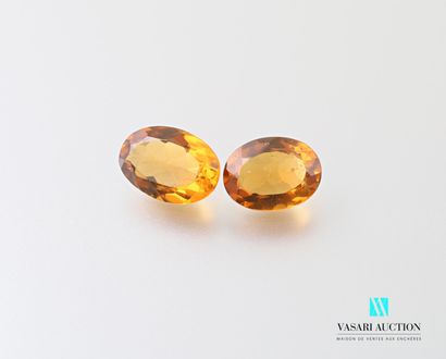 null Two oval faceted Madeira citrines on paper of approximately 5.5 and 6 carats...