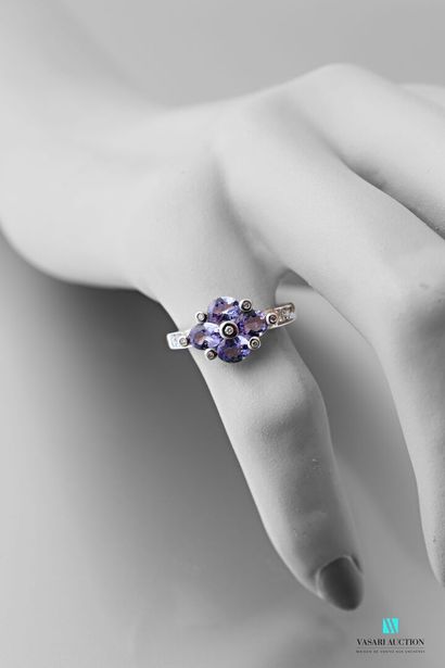 null 750 thousandths white gold ring adorned with four oval-shaped tanzanites interspersed...