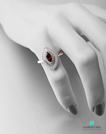 null 925 sterling silver ring set with a garnet surrounded by two rows of white stones...