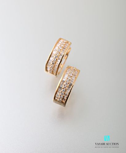 null Pair of creoles in 750 thousandths yellow gold adorned with a line of round...