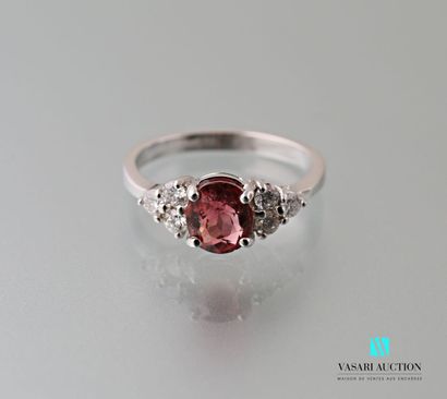 null A 750 thousandths white gold ring set with an oval-shaped peach-coloured tourmaline...