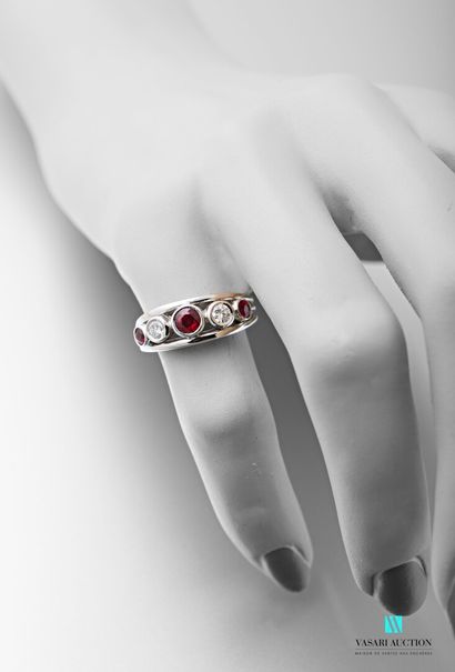 null 750 thousandths white gold river ring set with three round rubies interspersed...