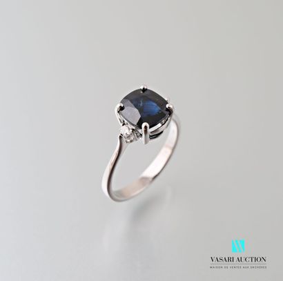 null 750 thousandths white gold ring set in its centre with a cushion-cut sapphire...