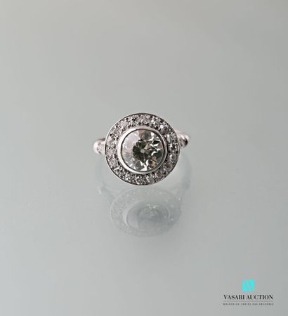 null 750 thousandths white gold ring set with a central antique cut diamond of approximately...
