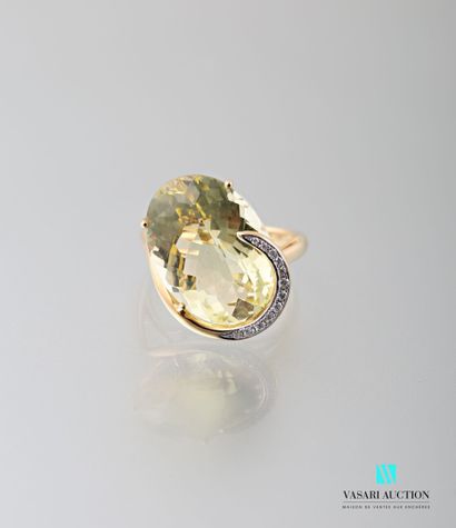 null 750 thousandths yellow gold ring adorned in its centre with a faceted oval faceted...