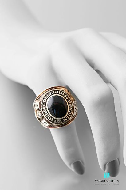 null 9 karat gold university ring set with a cabochon onyx encircled by the inscription...