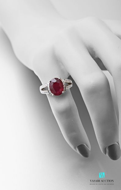 null 750 thousandths white gold ring set with an oval-shaped treated ruby calibrating...