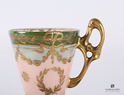 null Tasse et sa sous-tasse en porcelaine blanche à décor doré d'une frise de feuilles...