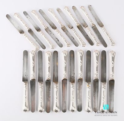 null A suite of twelve table knives and eleven dessert knives, the handles in silver...