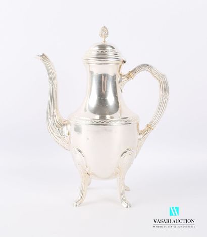 null A silver pot resting on four arched feet adorned with flutes and ribbons crossed...