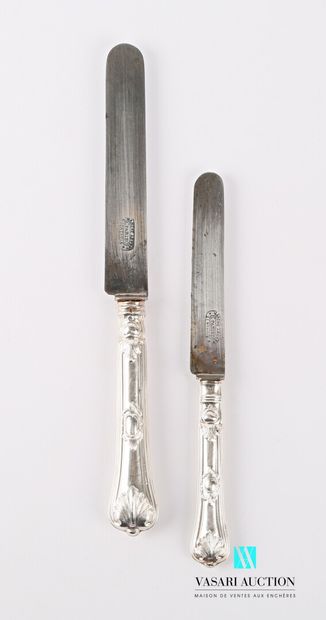 null A suite of twelve table knives and eleven dessert knives, the handles in silver...