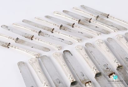 null A suite of twelve table knives and eleven dessert knives, the handles in silver...