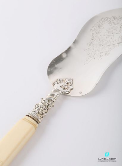 null A tart spatula in the shape of a violin is engraved with a drinking figure in...