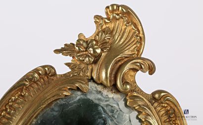 null Face to hand in bronze, the bevelled oval view mirror is set in a medallion...