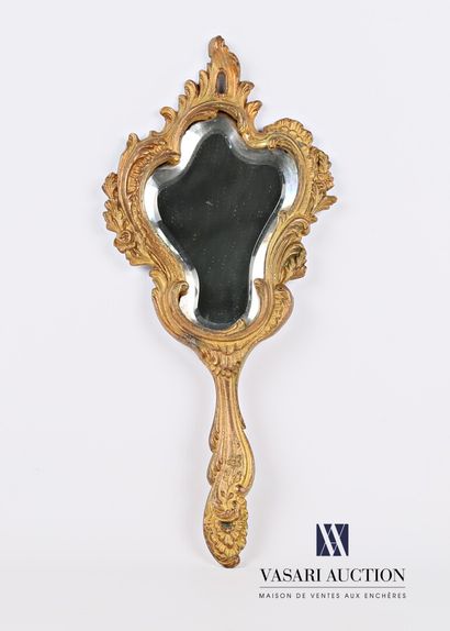 null The bevelled mirror, with its bevelled shape, is hemmed with waves, foliage...