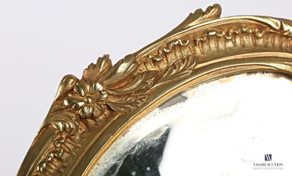 null Face to hand in bronze, the bevelled oval view mirror is set in a medallion...