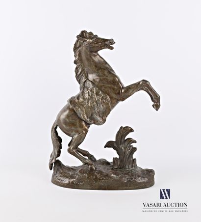 null Subject in ruler with grey-brown patina representing a rearing horse on a leafy...