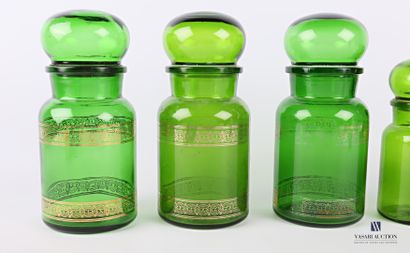 null A suite of five apothecary jars in green tinted glass, the ball stoppers decorated...