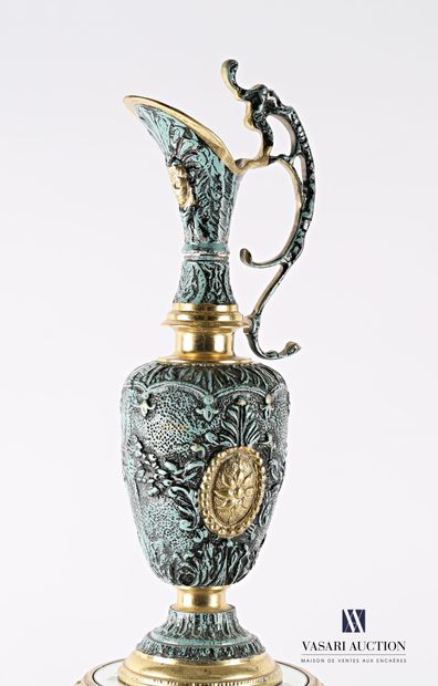 null Ewer and its bronze selette with a teal blue patina, decorated in relief with...