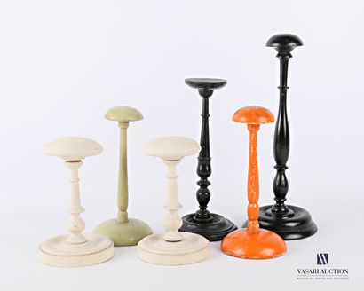 null Six turned and lacquered wooden wig holders in white, black, green and orange.

(wears)

High....