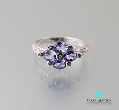 null 750 thousandths white gold ring adorned with four oval-shaped tanzanites interspersed...