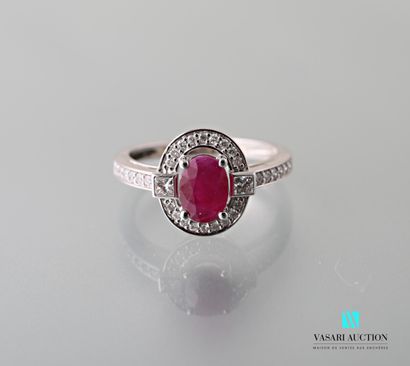 null A 750 thousandths white gold ring set with an oval ruby calibrating 1.06 carat,...