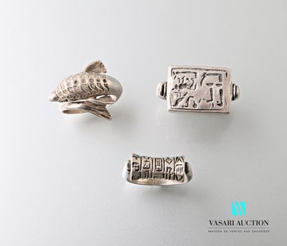 null Set comprising three silver rings, one of which depicts a dolphin, the other...
