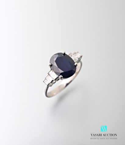 null White gold ring set with an oval-shaped sapphire calibrating approximately 2.95...