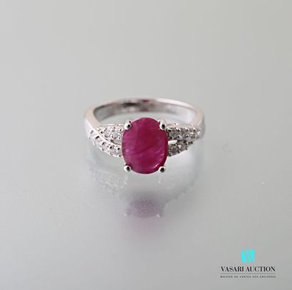 null 750 thousandths white gold ring set with an oval-shaped ruby of approximately...