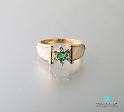 null 750 karat yellow gold ring with a floral motif of a central emerald surrounded...