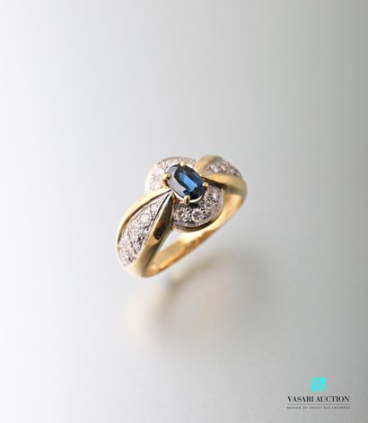 null 750-thousandths yellow gold ring set with an oval-shaped sapphire calibrating...