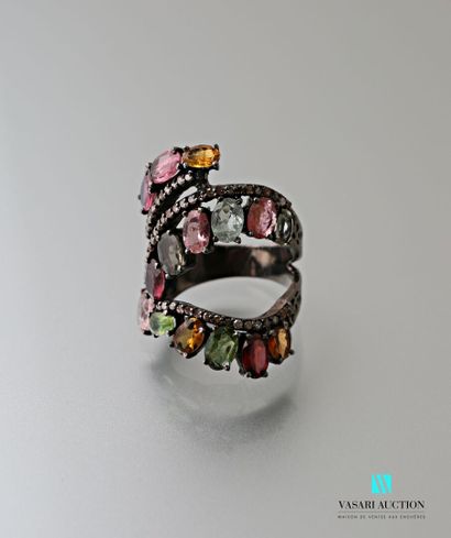 null A patinated silver ring with an openwork and saymetric body adorned with oval-cut...