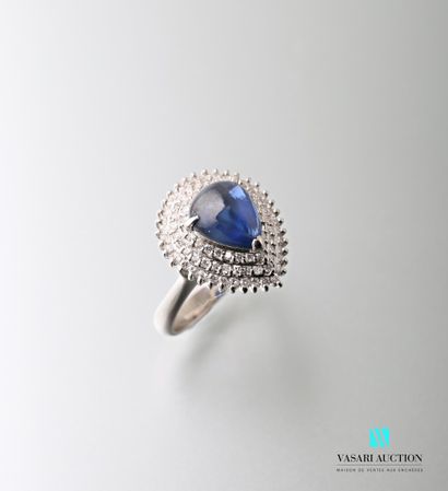 null 900-thousandths platinum ring set with a pear cabochon-cut sapphire calibrating...